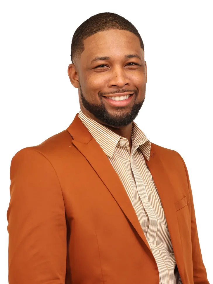 Xavier DeBrough in an orange blazer