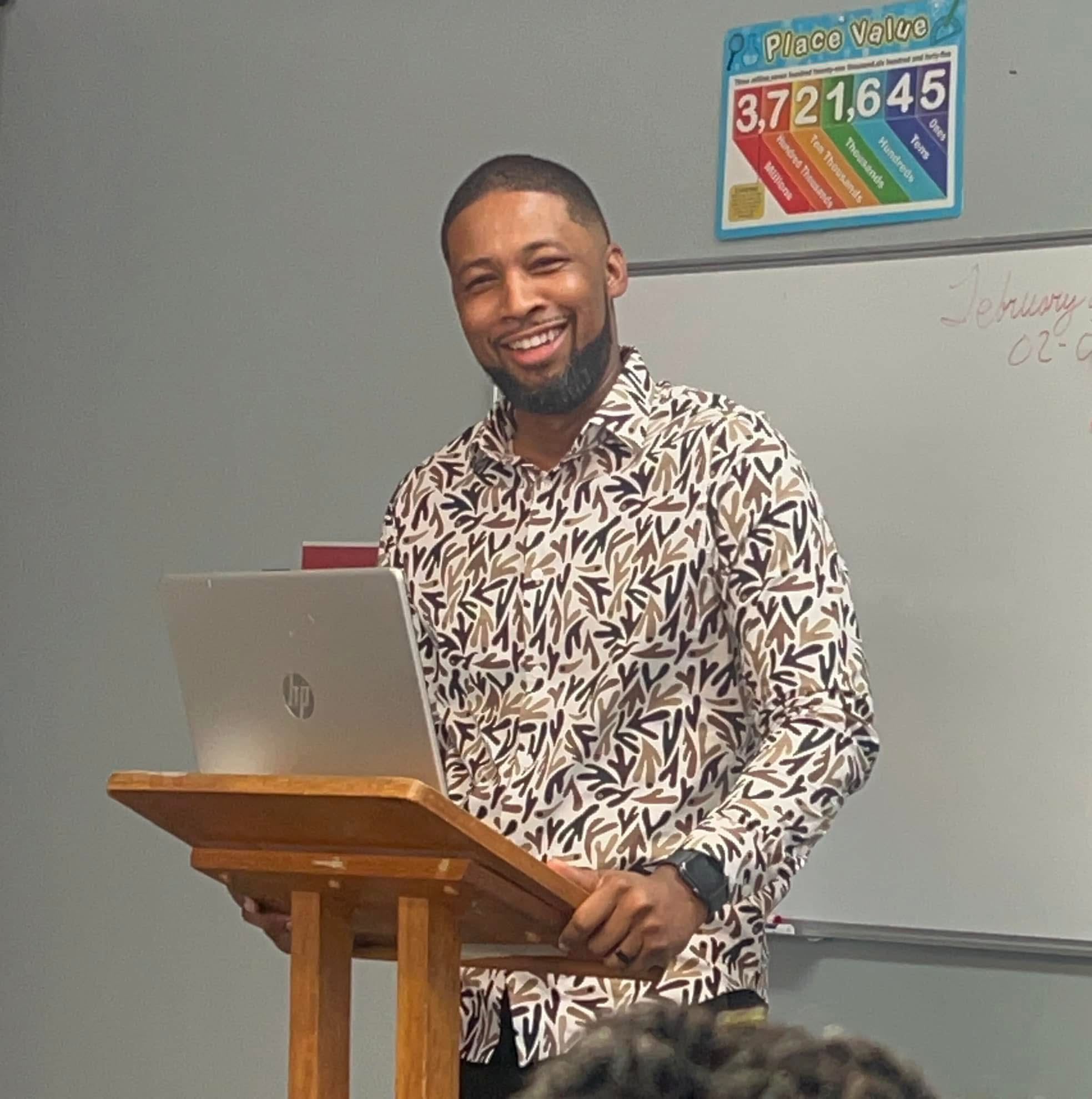 Xavier DeBrough speaking at a podium