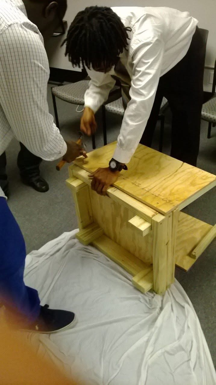 Student building a birdhouse hands-on