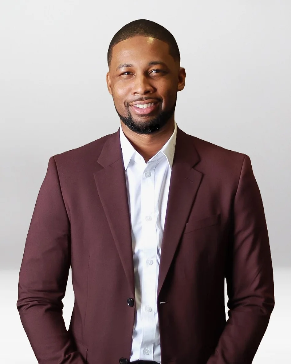 Xavier DeBrough in a maroon suit