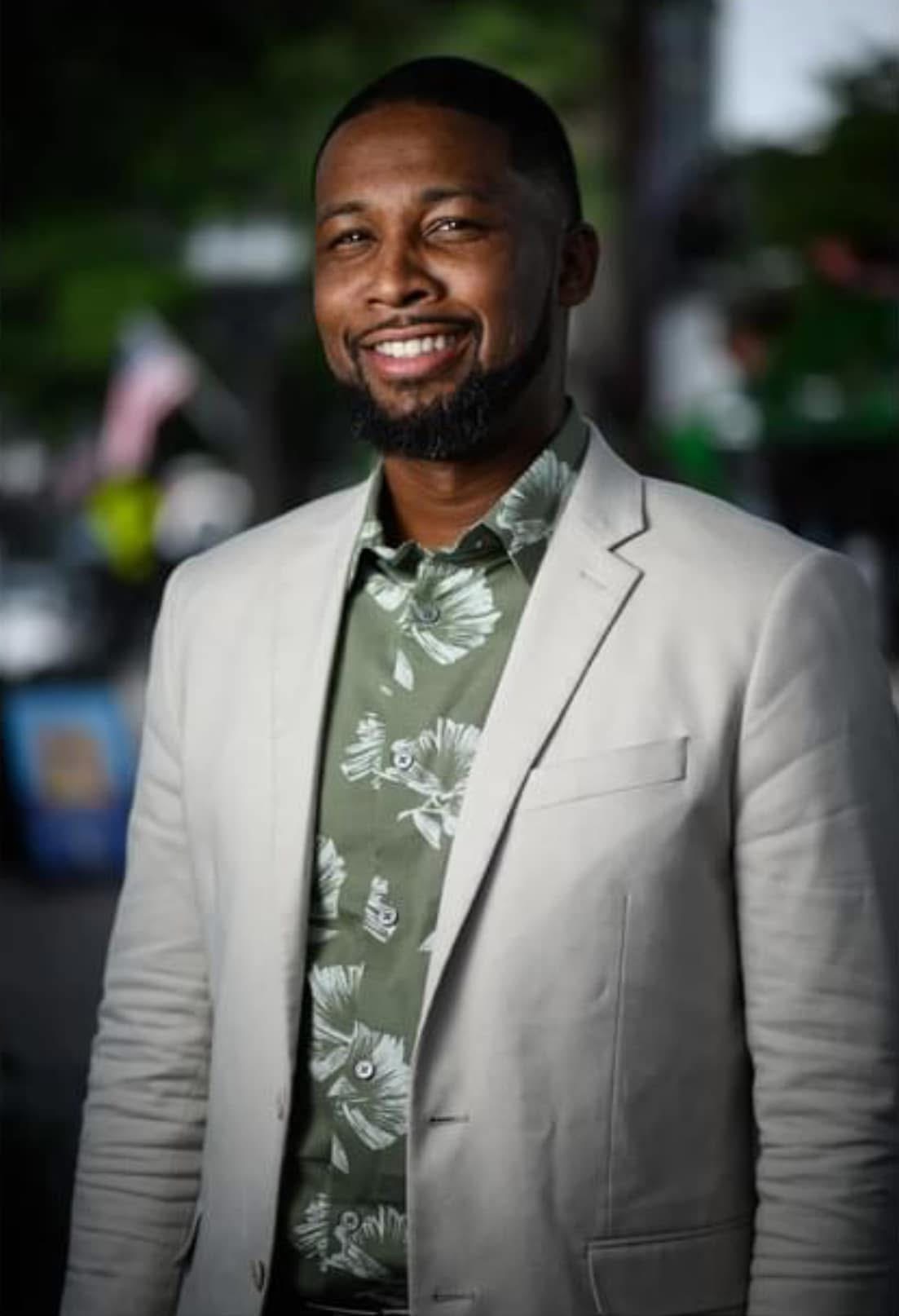 Xavier DeBrough in a grey suit